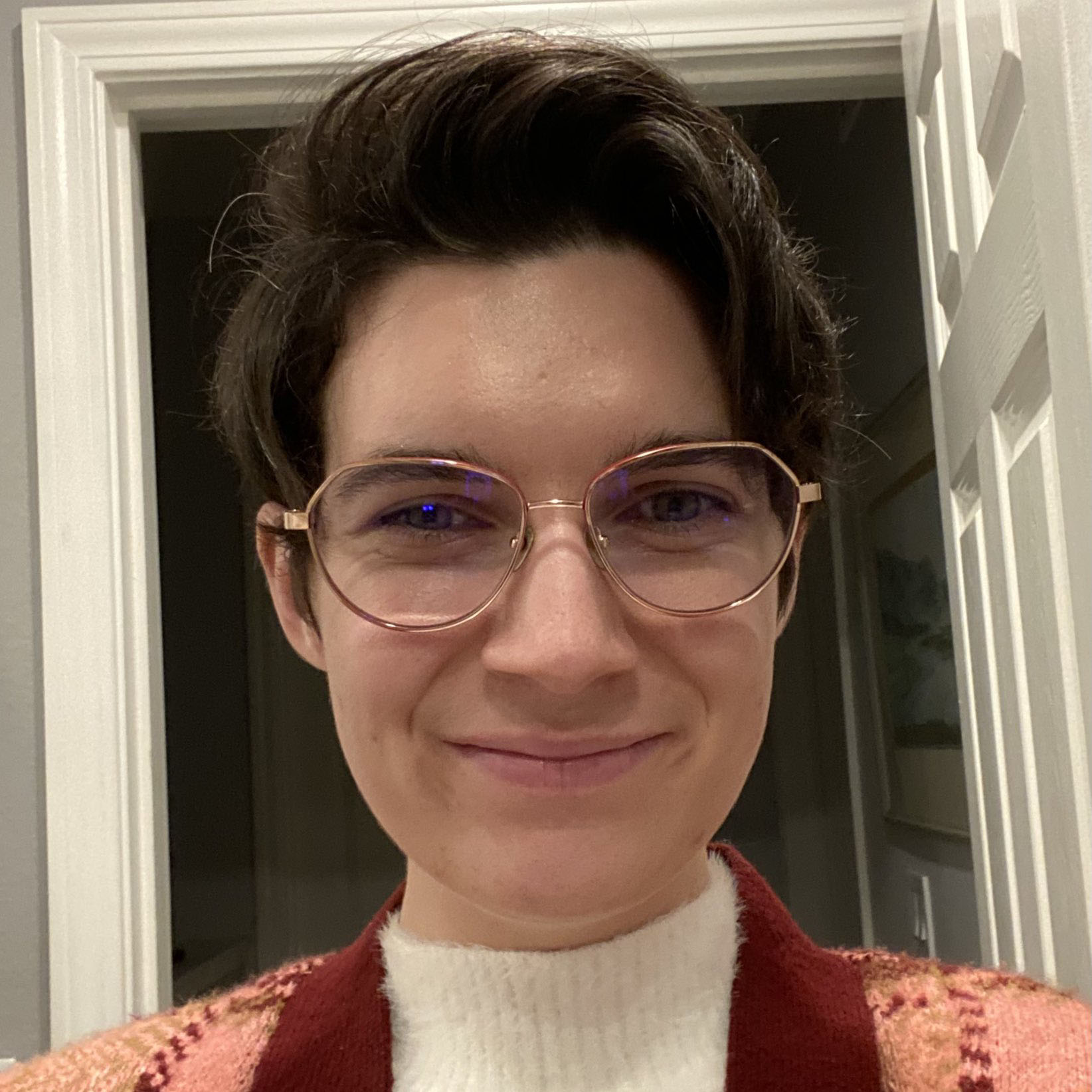 Headshot of Sophie Galley in front of an open doorway.